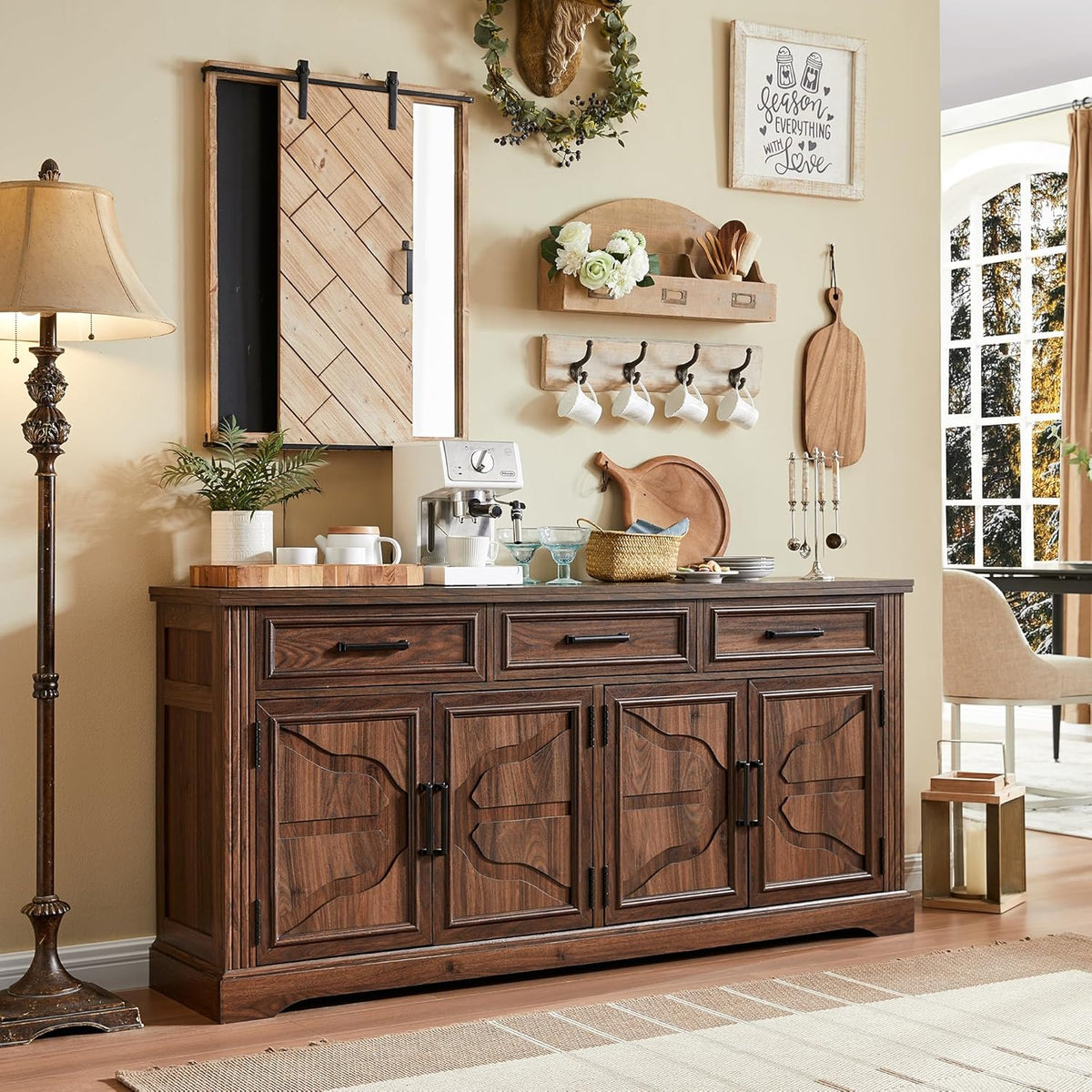Straight-on view of a warm brown wooden buffet with carved door panels in a cozy kitchen vignette.