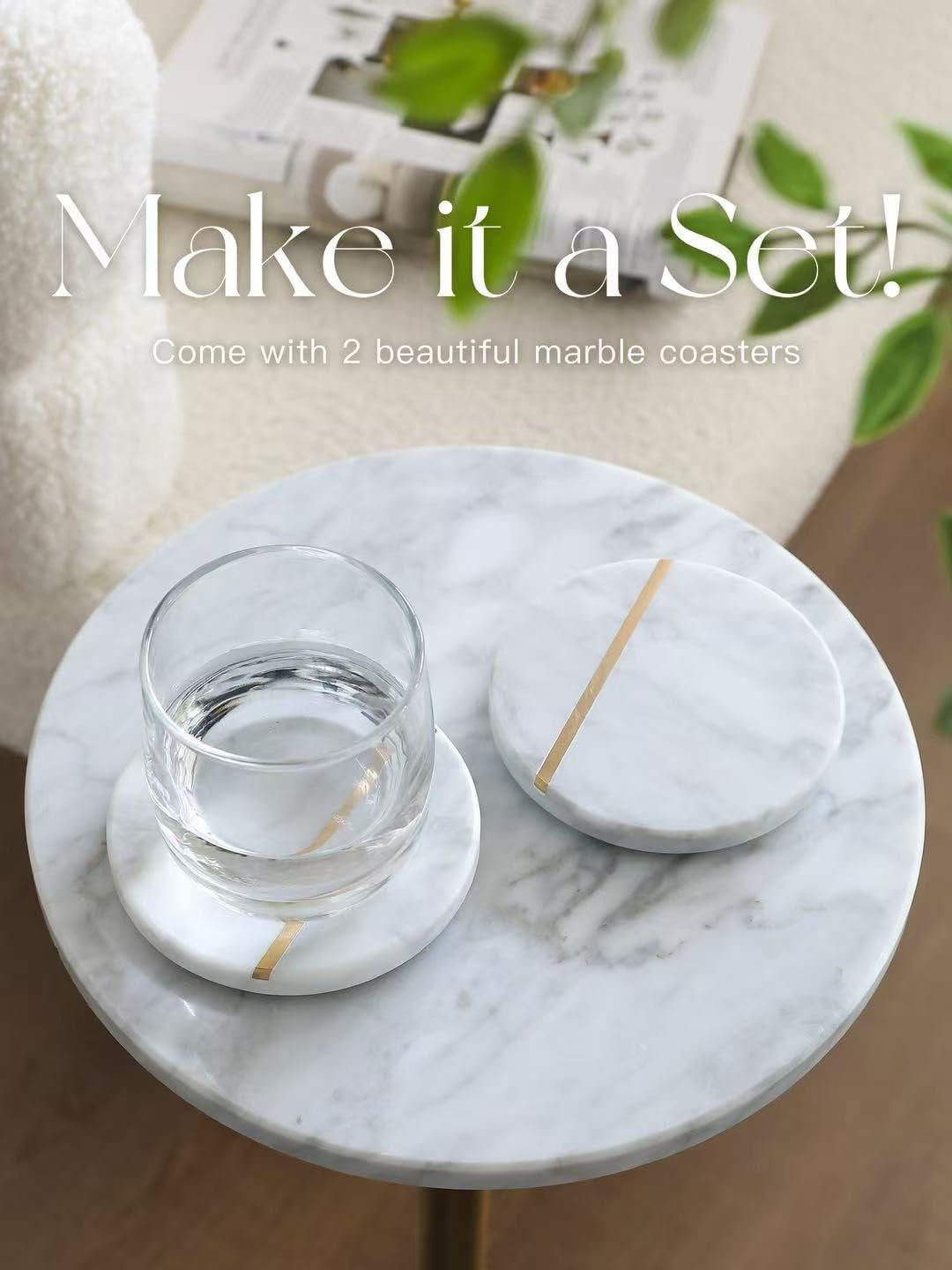Close-up of two white marble round coasters with a gold stripe on a marble tabletop