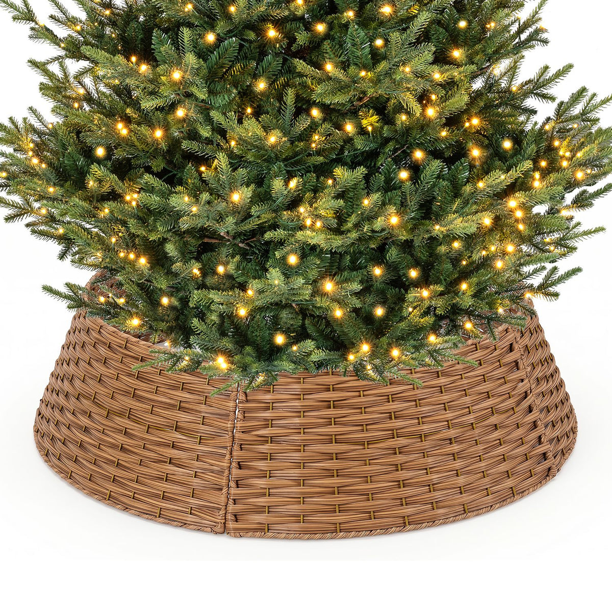 Lit evergreen tree rising from a woven collar against a plain white background.