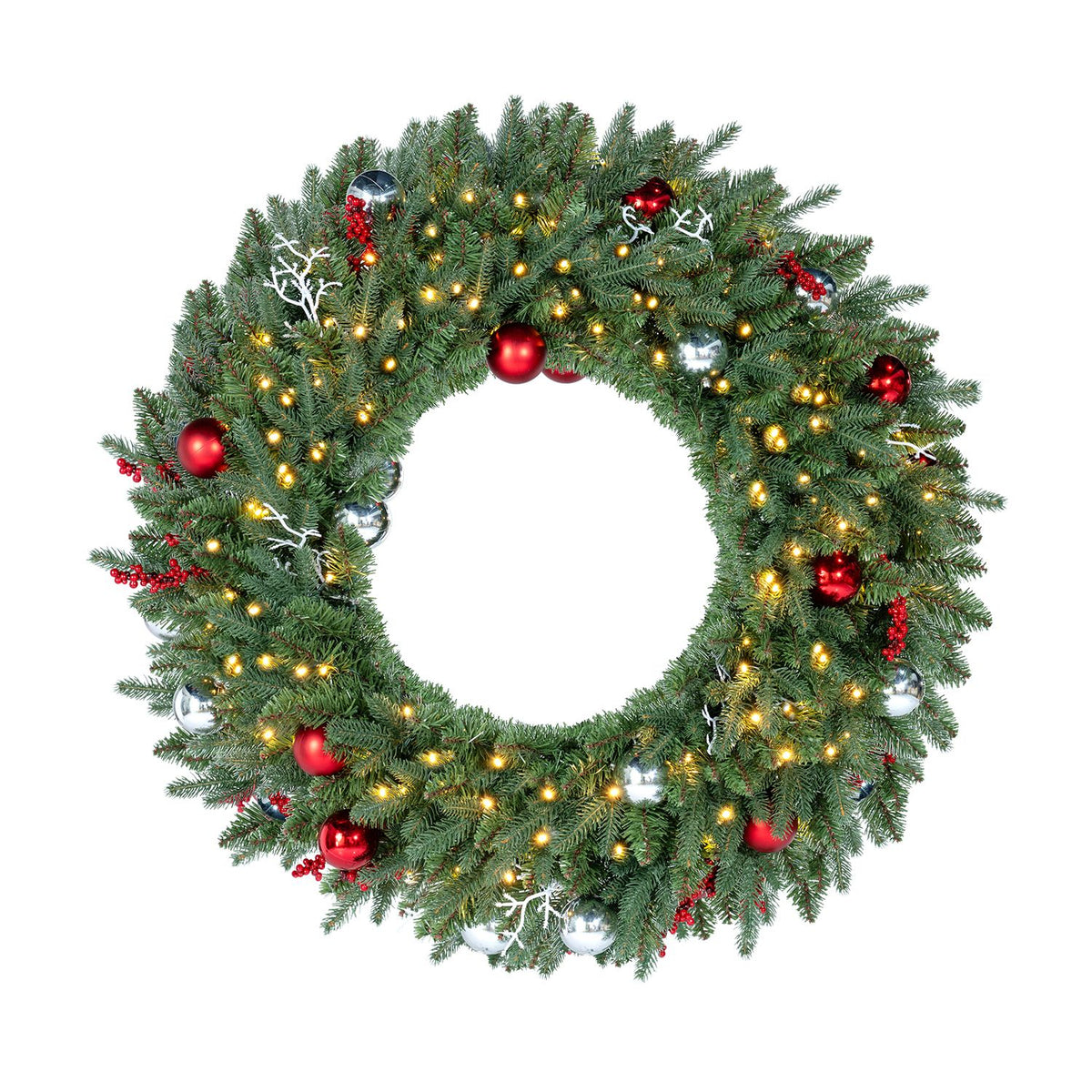 Evergreen wreath with warm lights, red and silver ornaments, and white decorative sprigs on a white background.