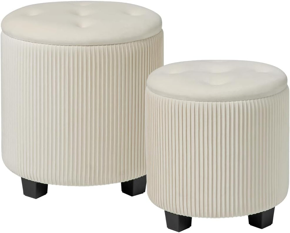 Two round cream velvet ottomans with vertical pleats and black block legs on white background