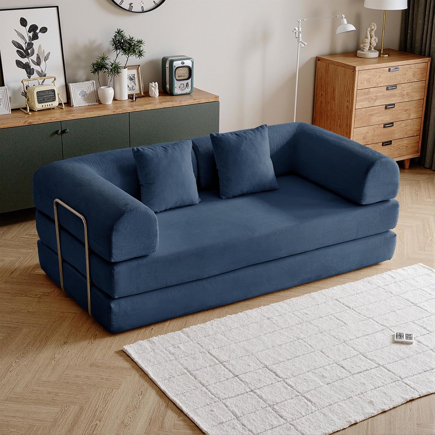 Full navy corduroy sofa setup with rounded armrests and three seat cushions in a living room