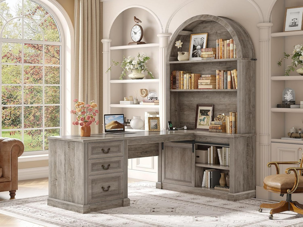 Gray-finish L-shaped desk with arched hutch filled with books, shown in a neutral-toned room by a large window.