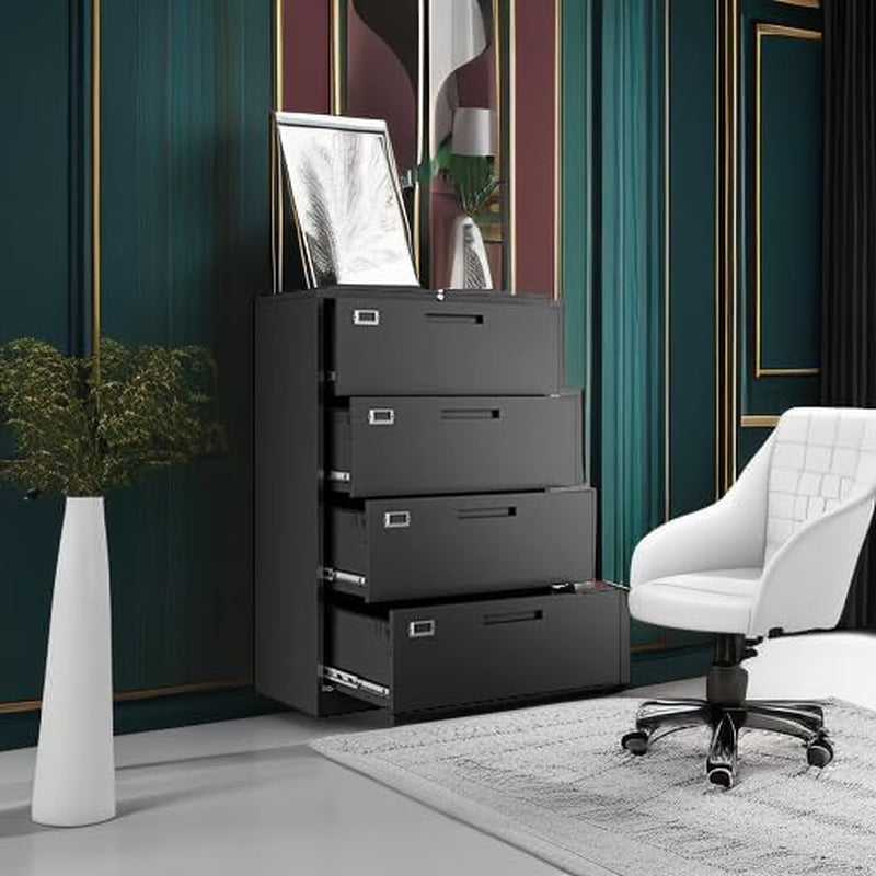 Four-drawer black filing cabinet against a decorative wall with a white office chair and floor vase nearby