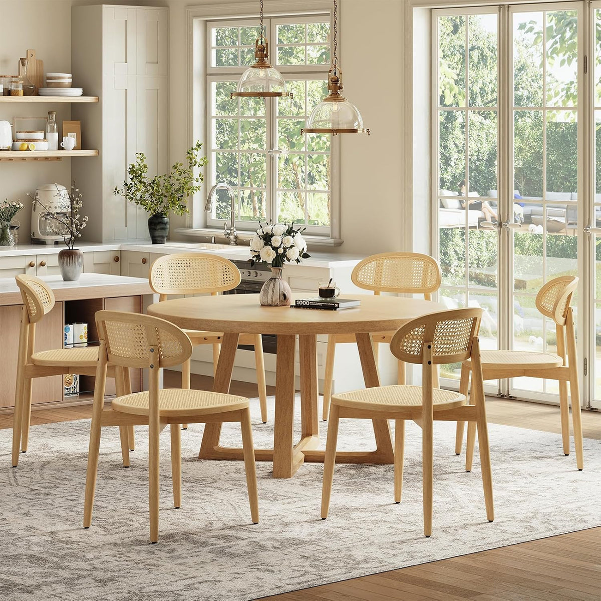 Six light-wood rattan-back dining chairs arranged around a round table in a sunlit kitchen.