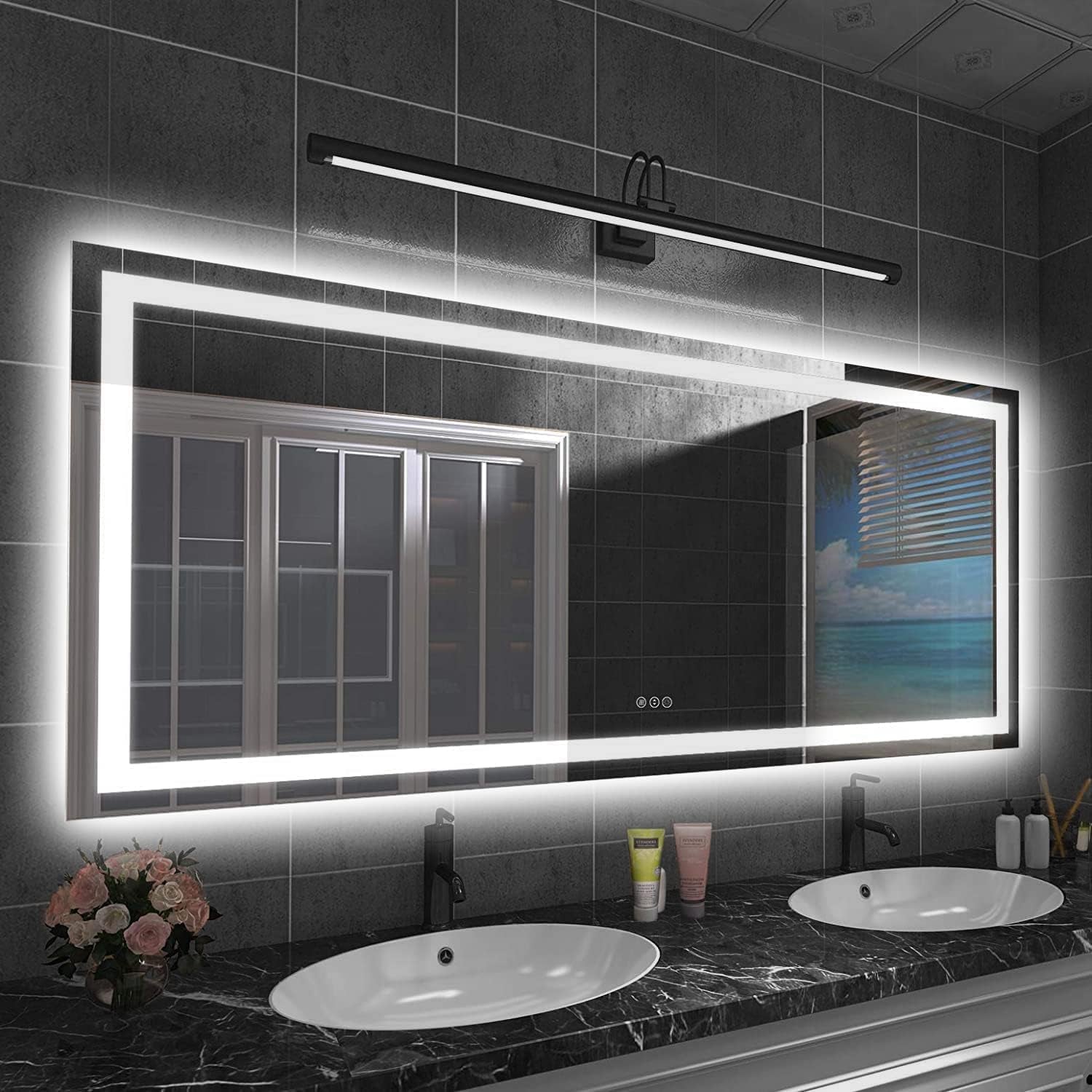 Wide horizontal LED mirror with halo lighting above a double-sink vanity and toiletries reflected in the glass