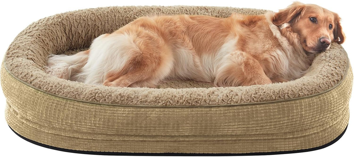 Oval tan plush dog bed with raised bolster, golden dog stretched out inside resting head on bolster