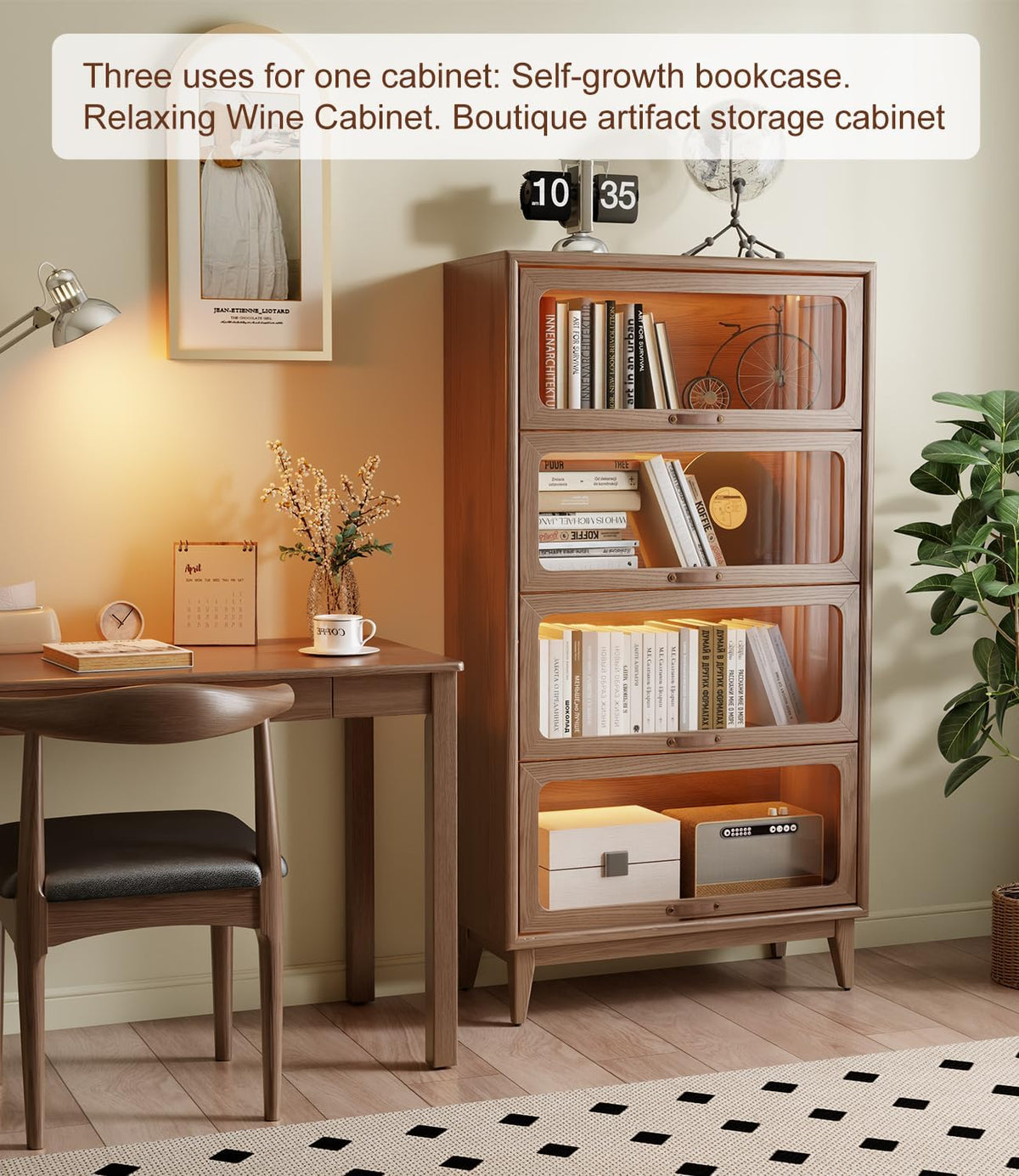 Four-tier wooden bookcase with glass-front doors beside a desk, filled with books and lit warmly in a styled room.