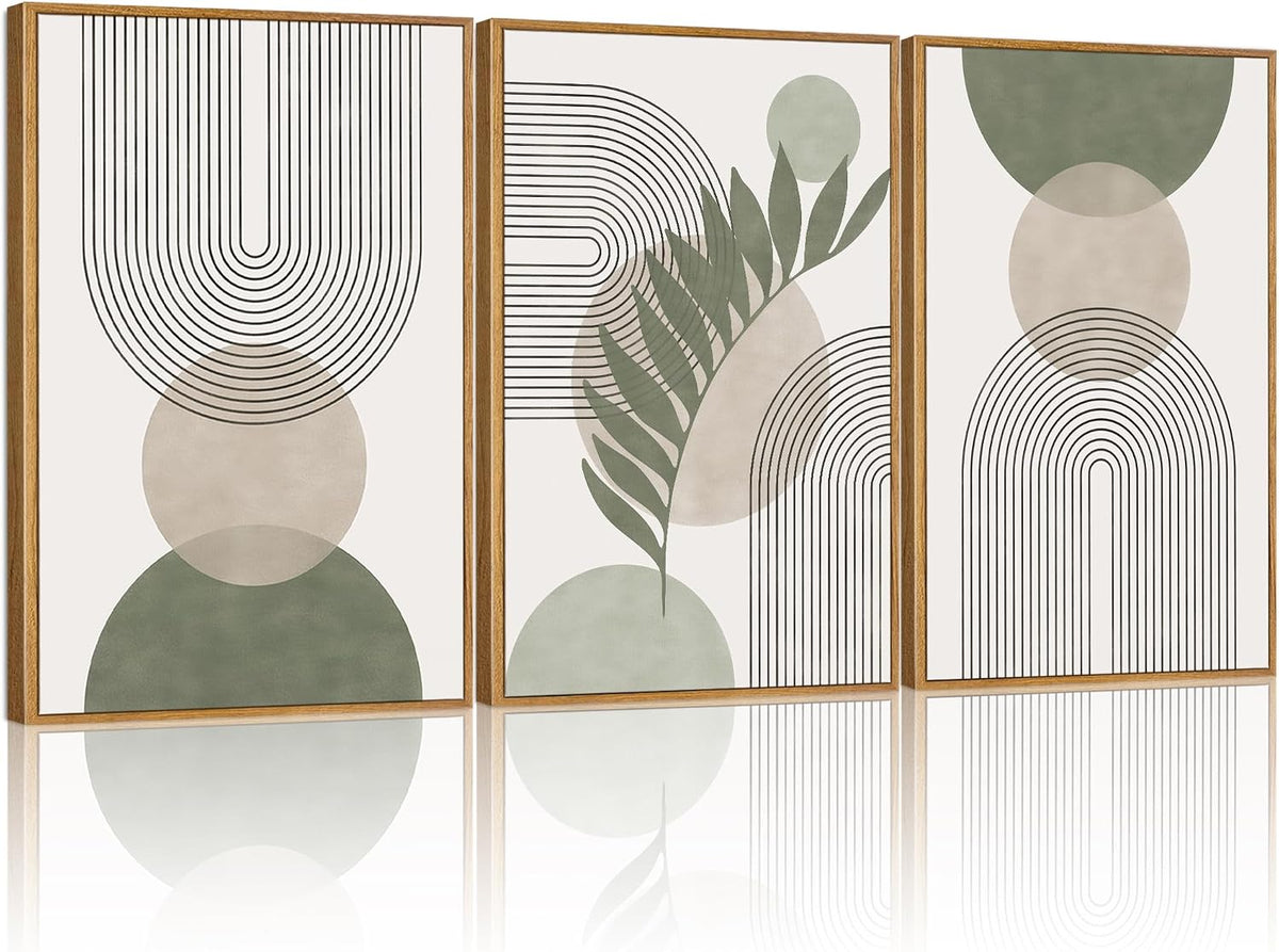 Three tall framed abstract prints with sage green circles, arching black line patterns and a leaf motif, reflected on a