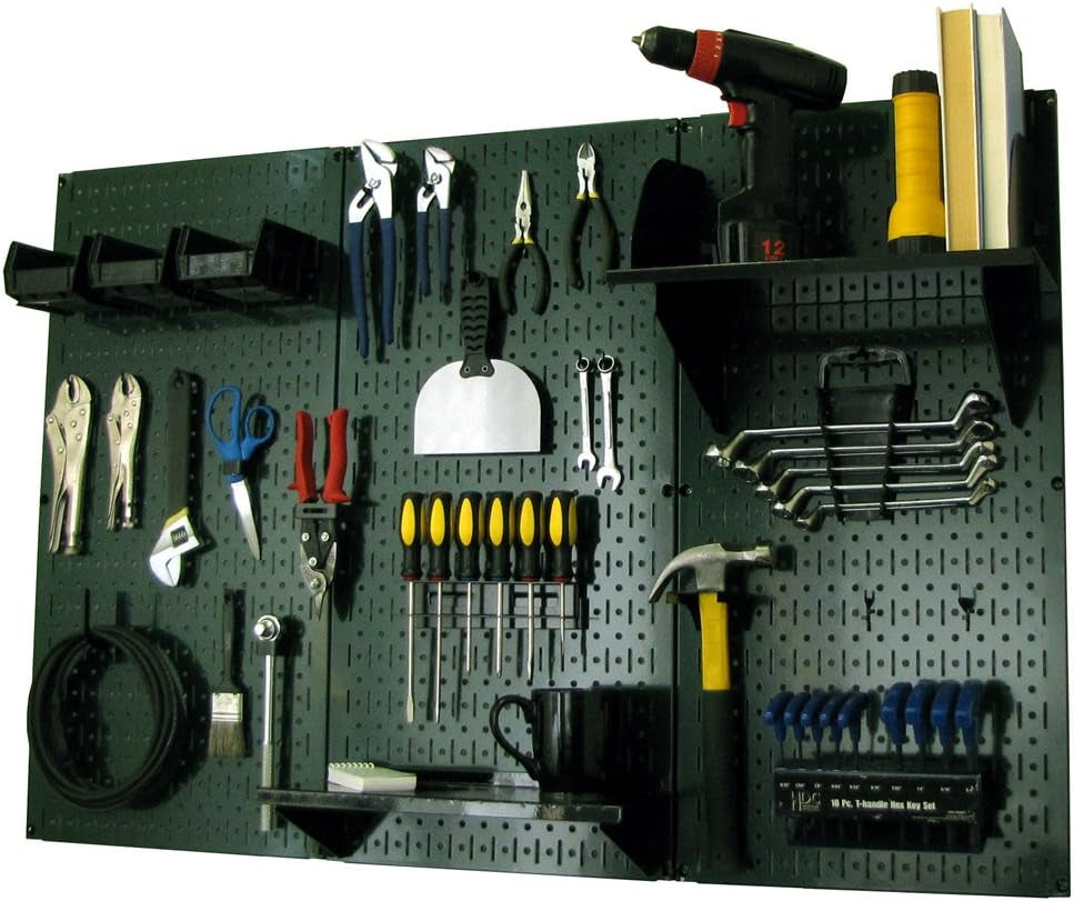 Black metal pegboard mounted with hand tools, a shelf, wrench rack and tool bins