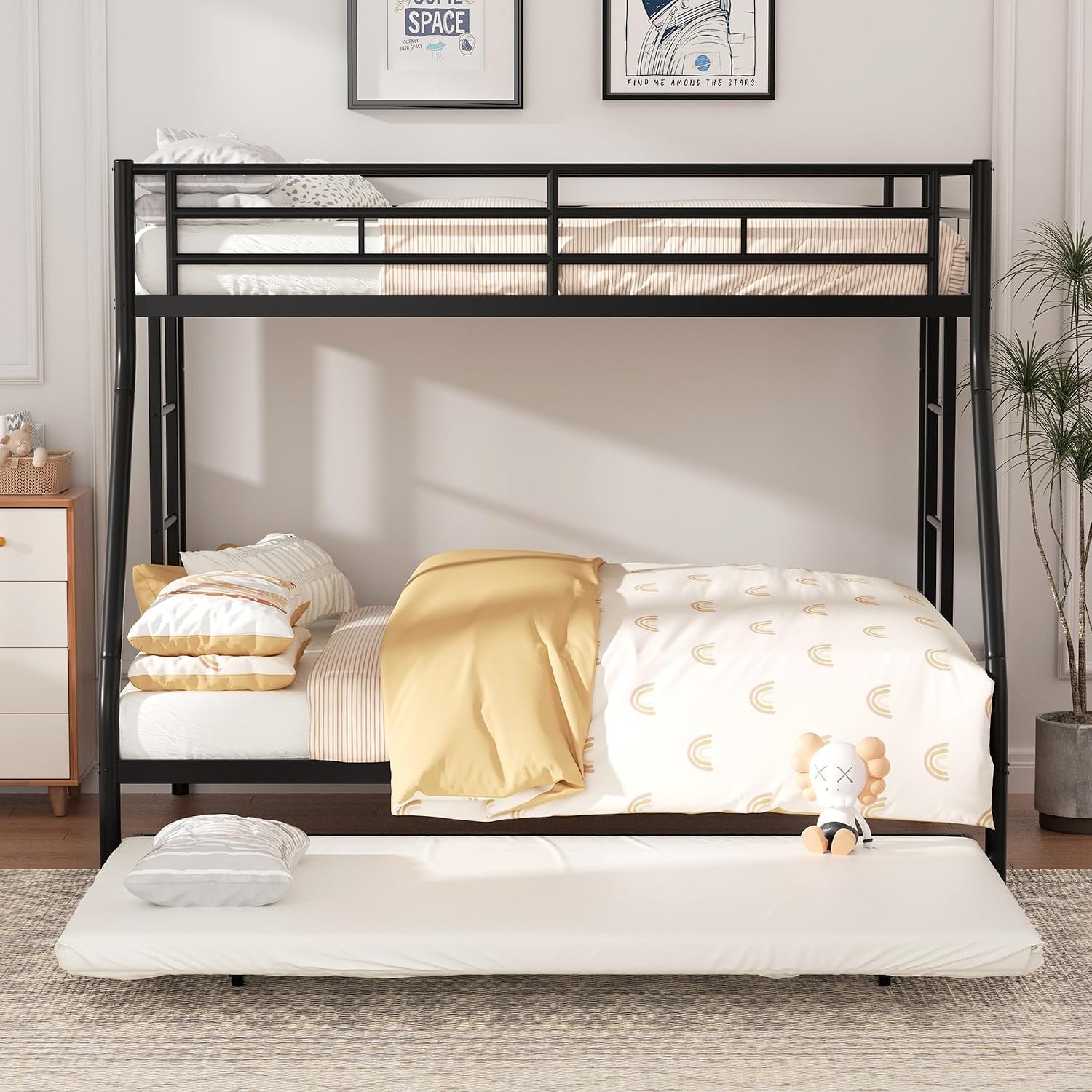 Front-facing view of black bunk bed with yellow-and-white bedding and trundle mattress pulled out on floor.