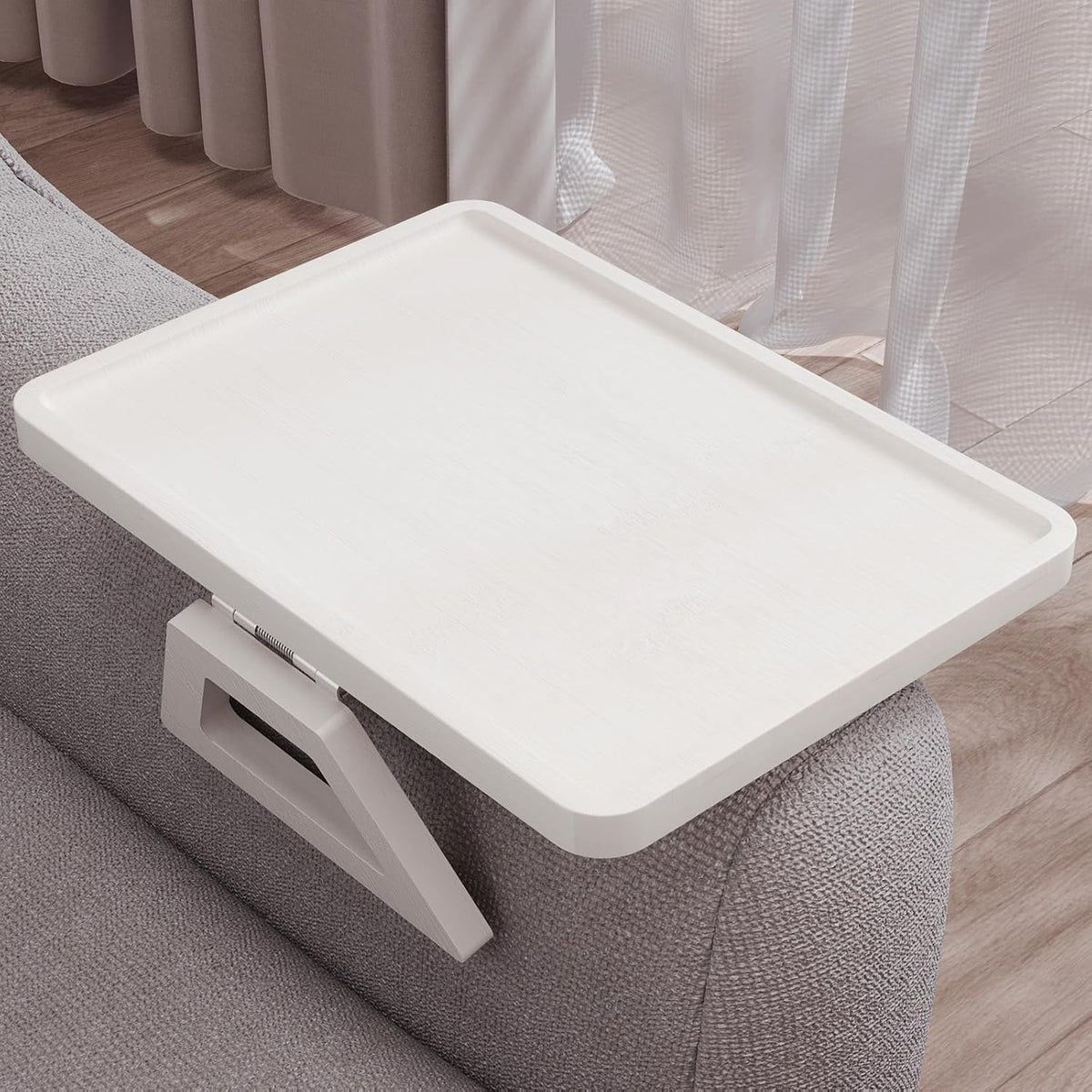 White-finished tray viewed from above, showing recessed rim and smooth wood grain on a sofa arm
