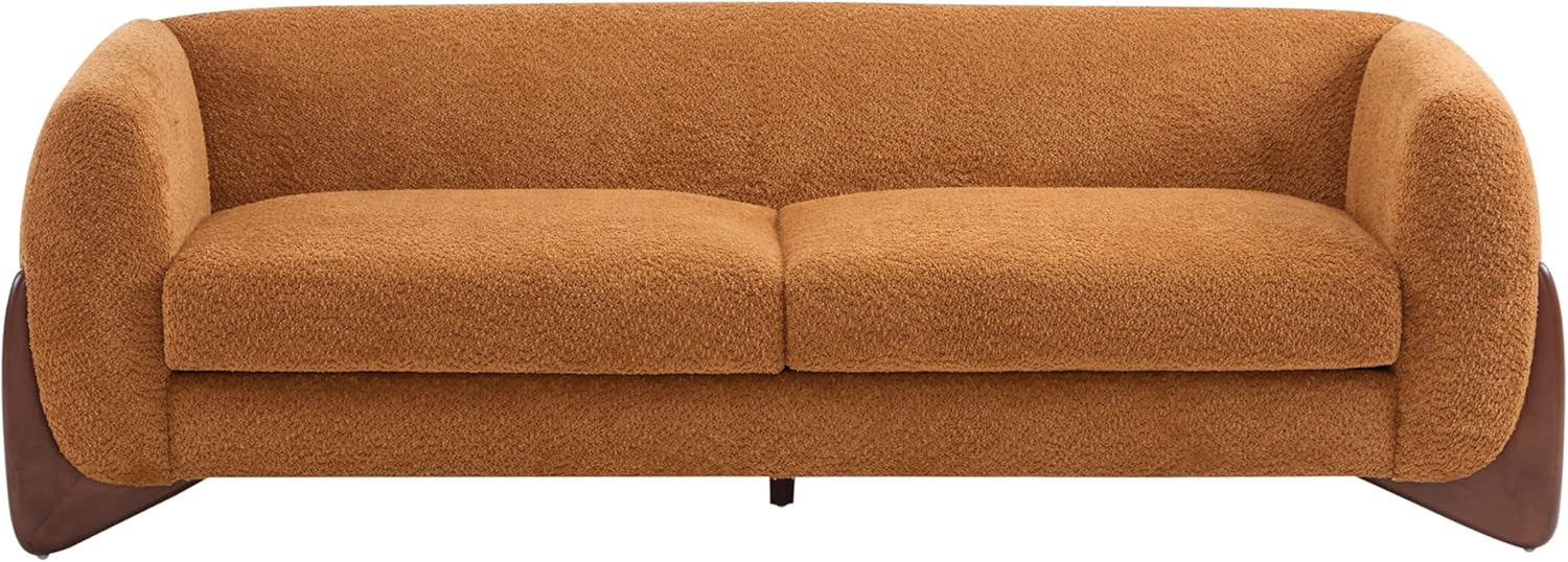 Front view of caramel three-seat sofa on a white background showing low rounded silhouette and cushions