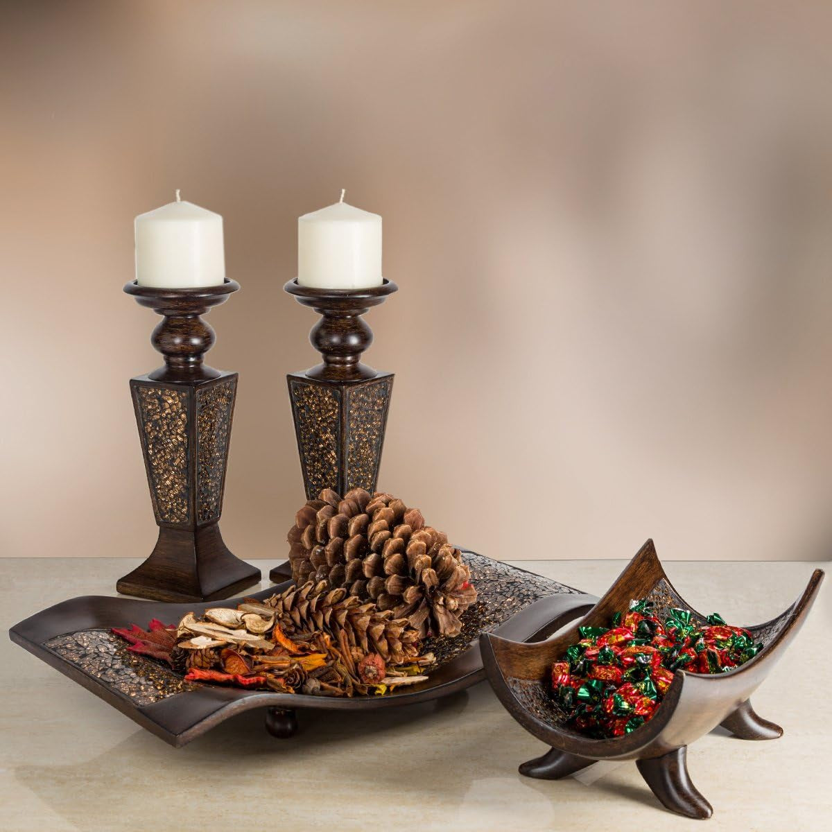 Two brown crackled mosaic candle holders displayed with a decorative tray of pine cones and seasonal accents