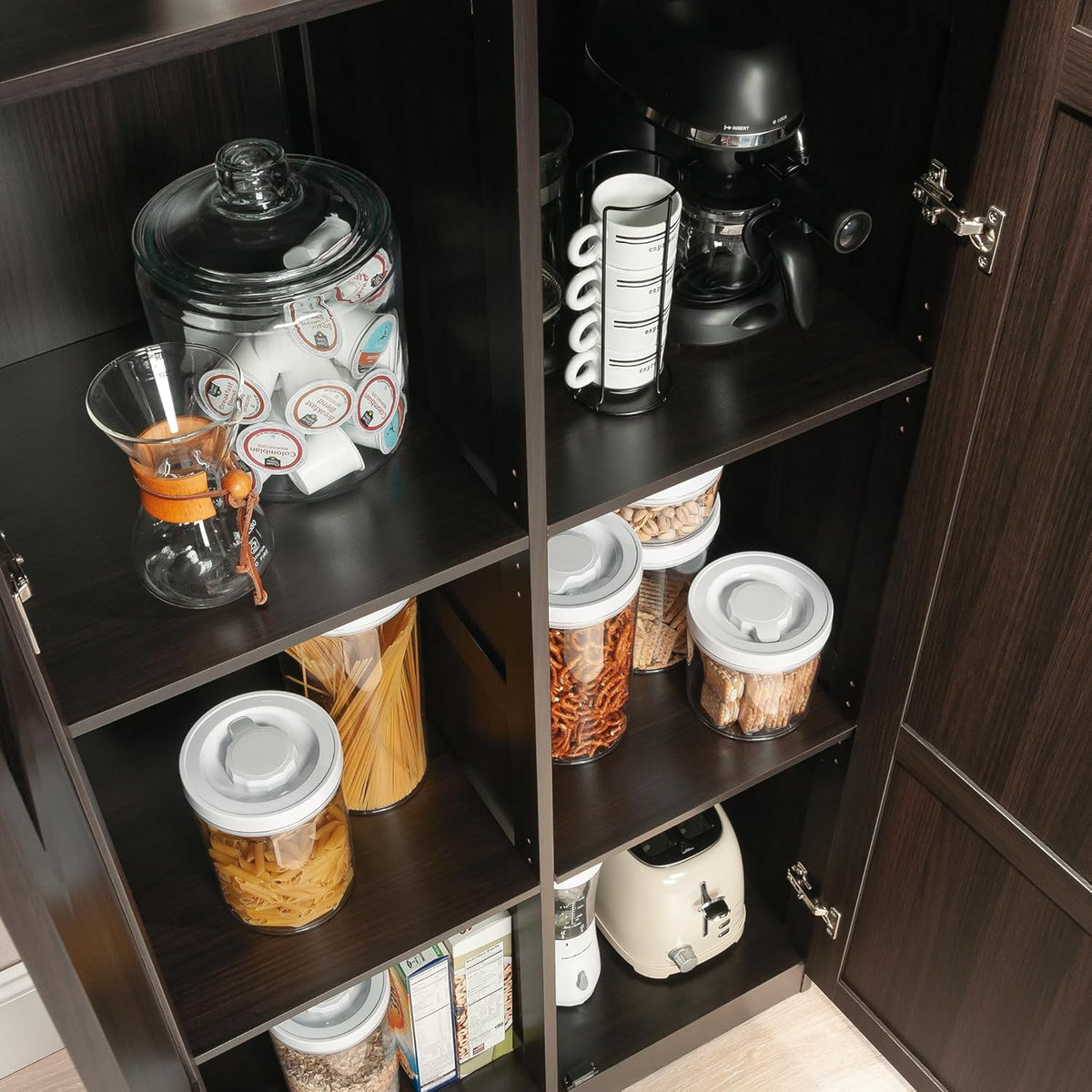 Close-up of interior adjustable shelves holding jars, pasta and small kitchen appliances