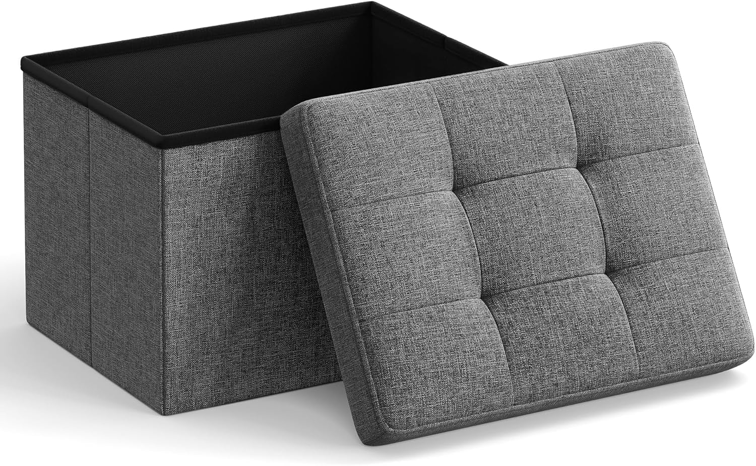 Dark gray linen-look folding storage ottoman with lid removed showing interior and tufted foam lid at an angle