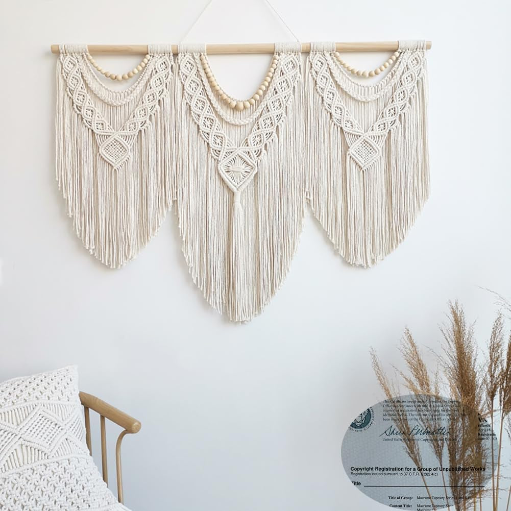 Ivory three-panel macrame hanging displayed above a chair in a bright room