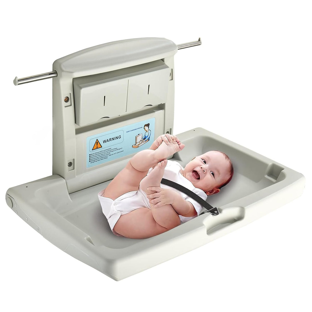 Wall-mounted fold-down baby changing station open with a smiling baby secured by a safety strap.