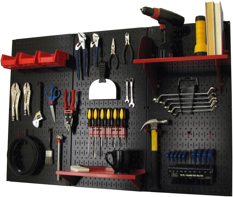 Black metal pegboard mounted with red shelves and hooks holding tools and a hammer