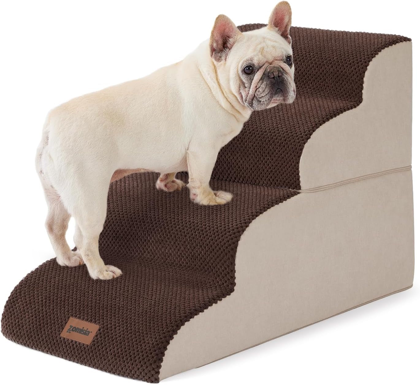 Cream-colored French bulldog standing on brown textured three-step pet stairs with beige sides