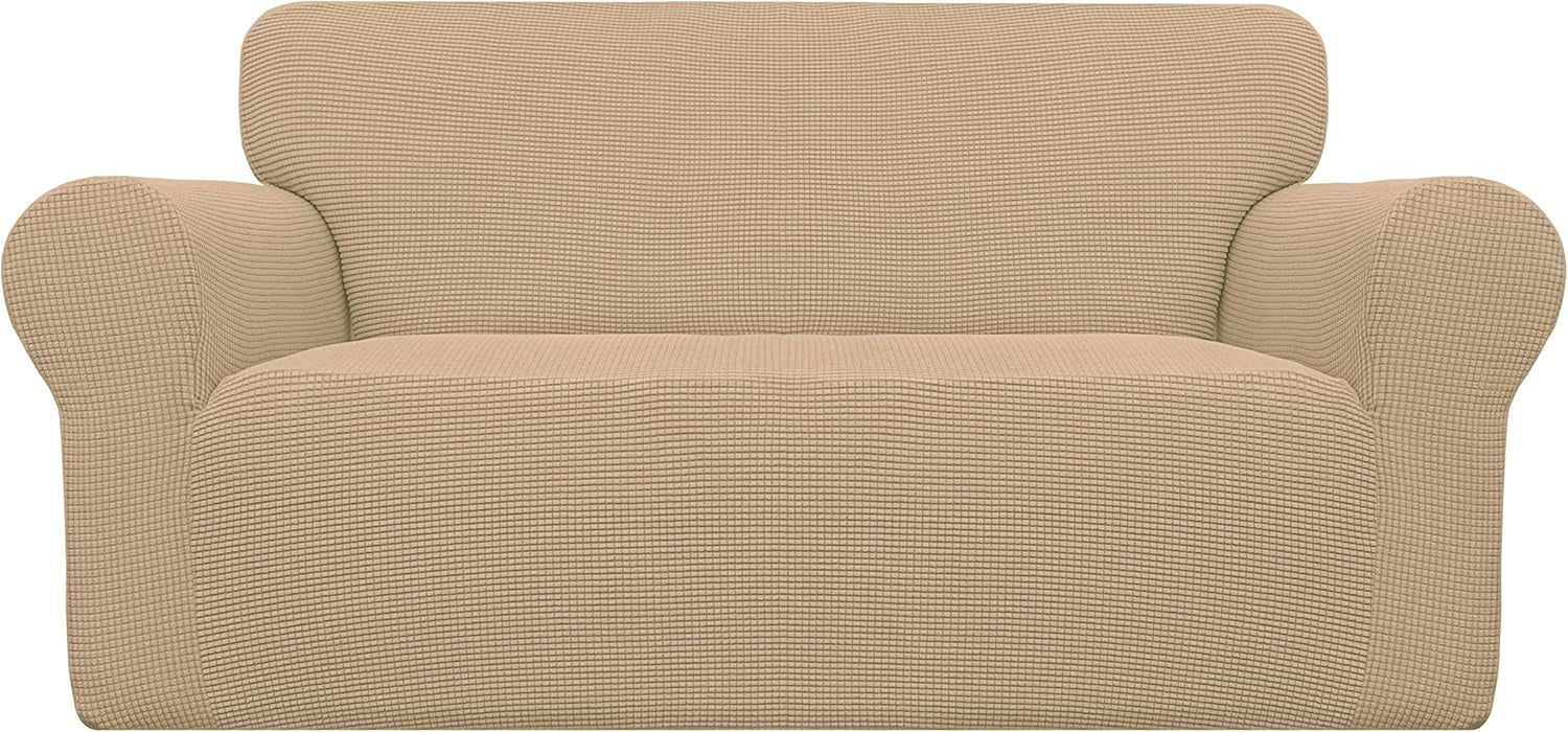 Front view of a two-cushion loveseat covered in a beige textured waffle-knit slipcover