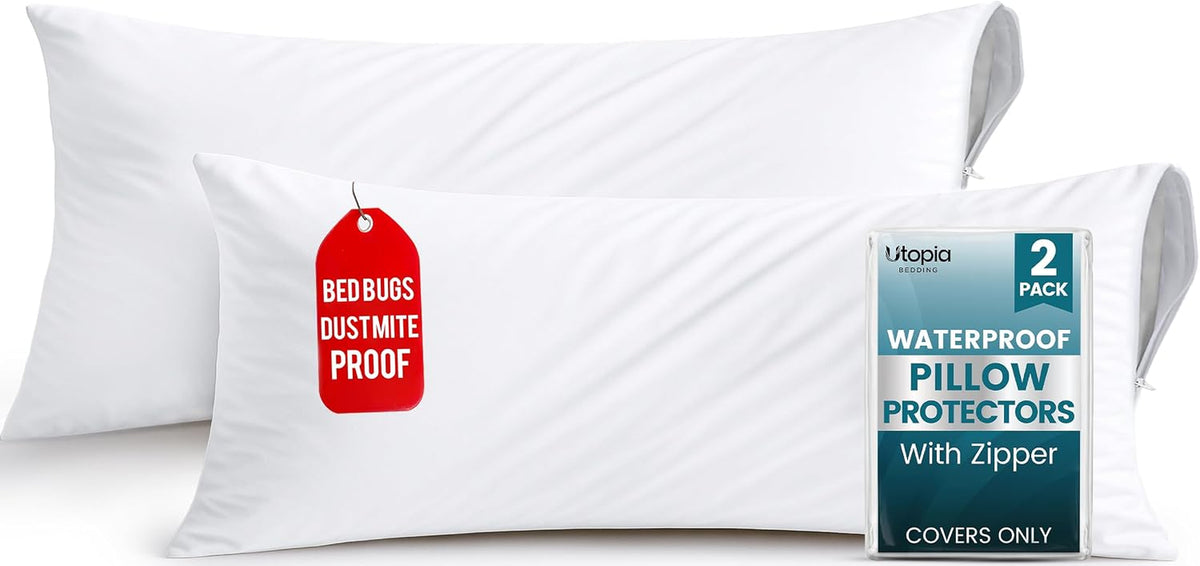 Two white pillows with visible zipper on the side and a small packaged insert propped against one pillow