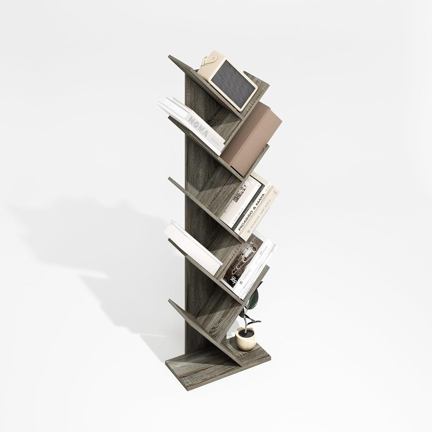 Tall zigzag book tower with diagonal shelves holding books and a small plant on a white background.