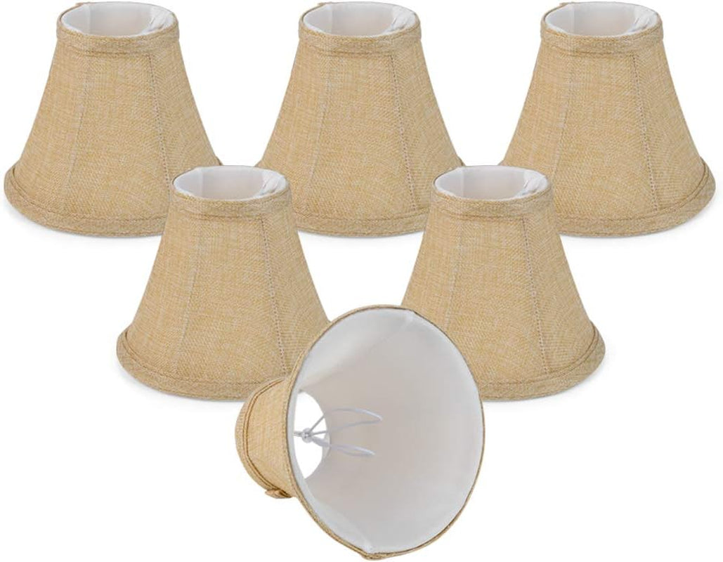 Six small cone-shaped clip-on lamp shades in natural tan, one turned over to show the white interior and clip fitter.