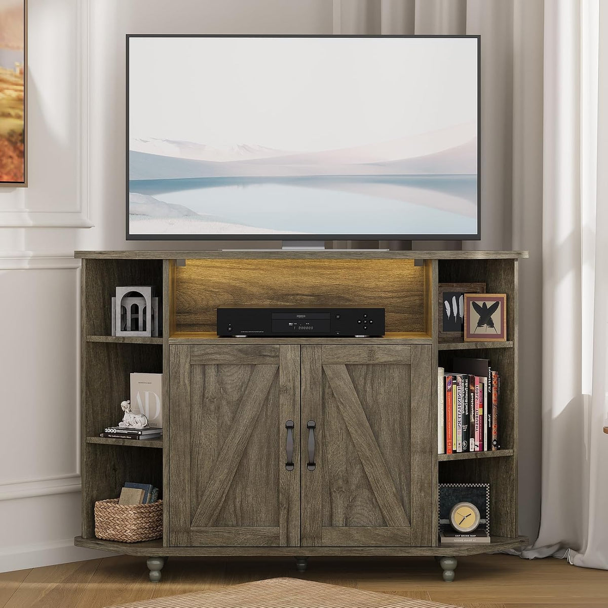 Weathered gray corner stand with TV, warm-lit equipment shelf and books and decor on the side shelves.