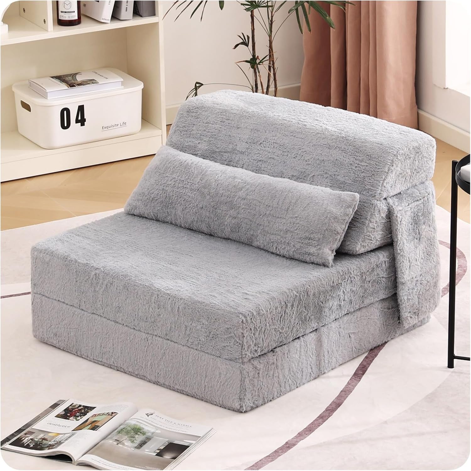 Light gray folding floor sofa with lumbar pillow set in a living room corner