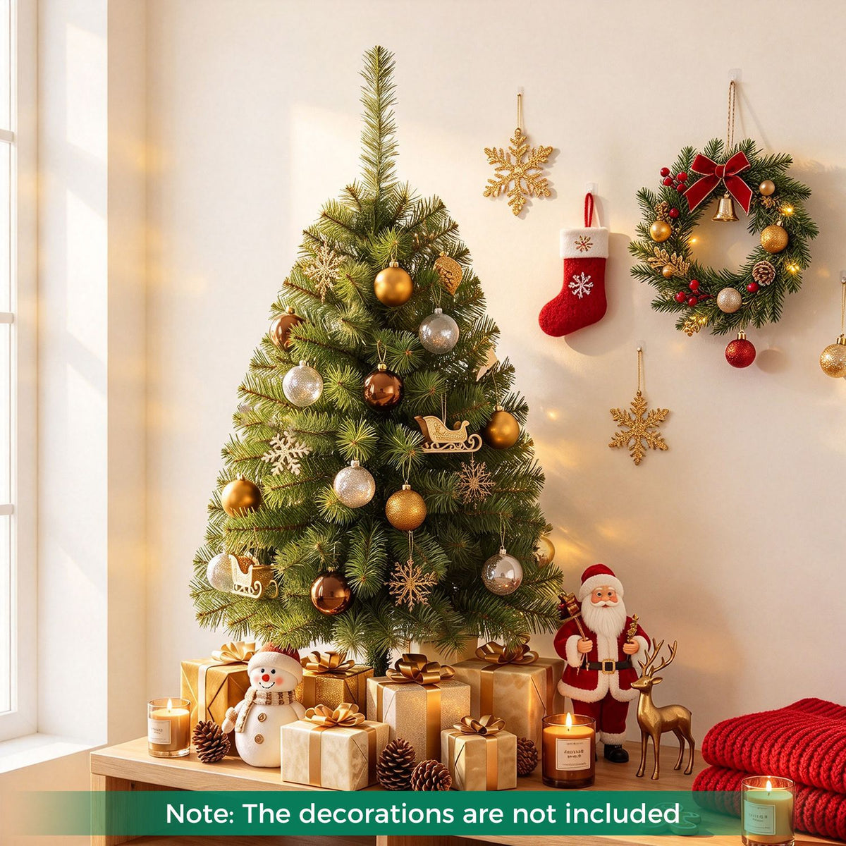 Decorated green tabletop Christmas tree surrounded by gifts, candles and holiday ornaments.