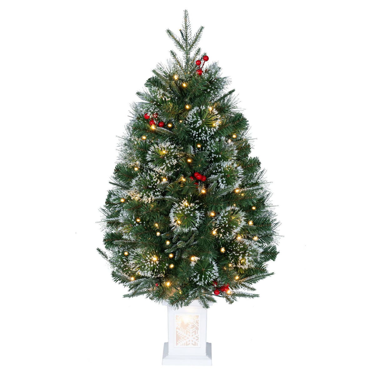 A single lit evergreen tree with red accents stands in a white square planter against a plain background.