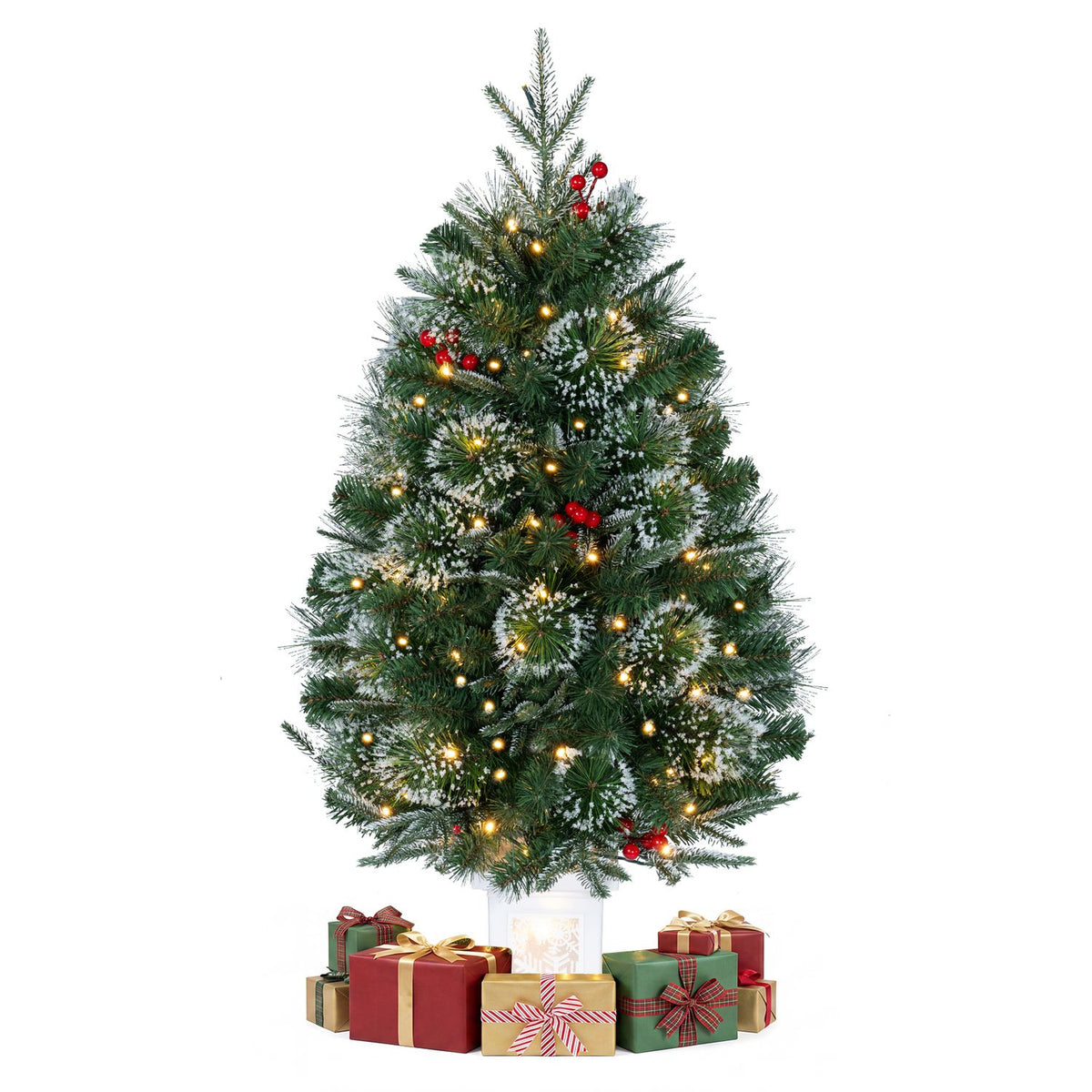 A lit evergreen tree in a white planter is shown against a plain background, surrounded by wrapped gifts.