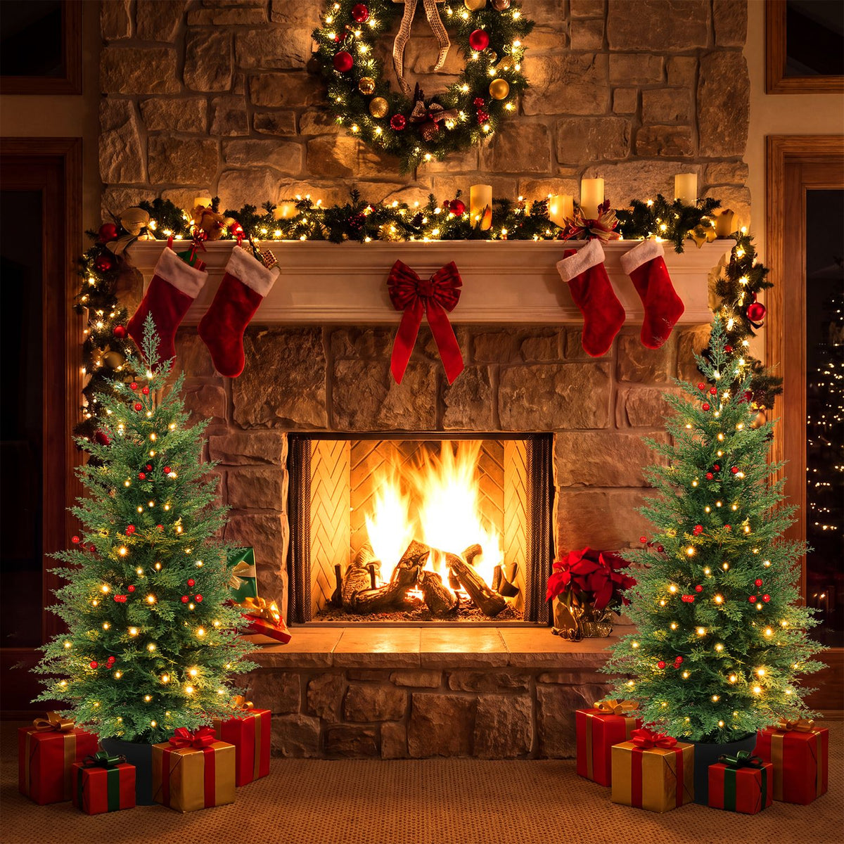 Two glowing potted Christmas trees stand beside a stone fireplace trimmed with garland and stockings.