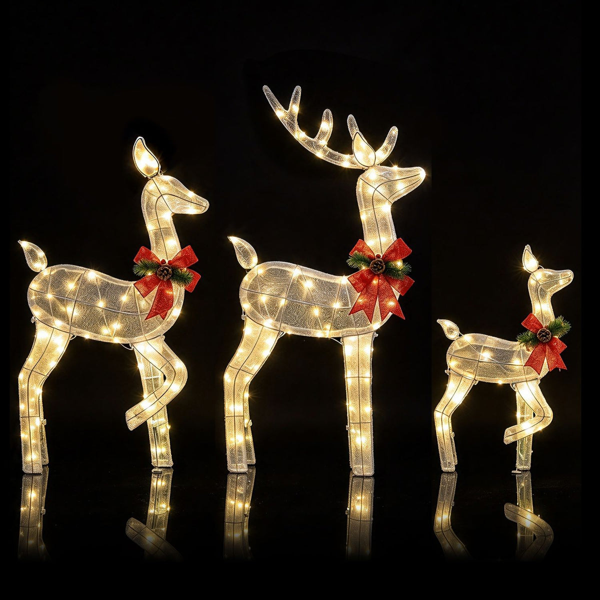 Three glowing reindeer figures with red bows are arranged against a black background.