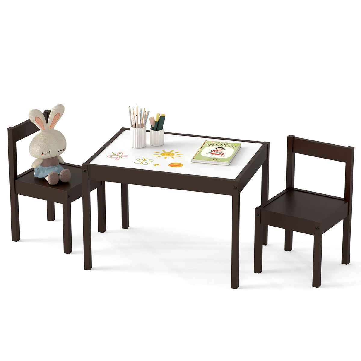 A dark wood table with a light top and two matching chairs, styled with a plush toy, art supplies, and a book.