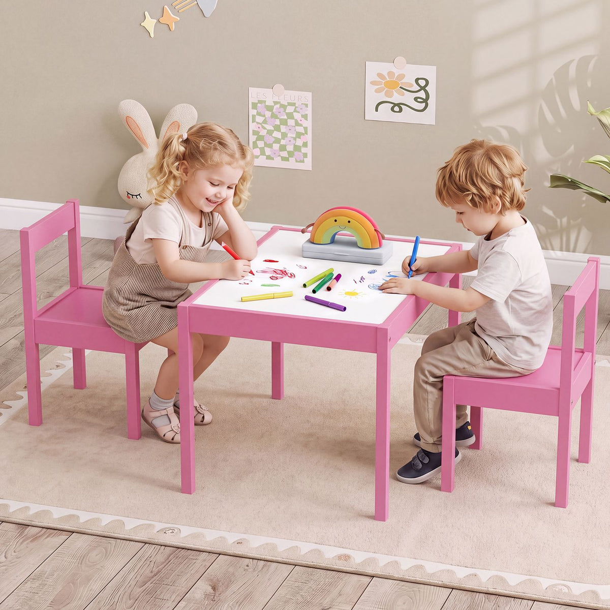 Two children draw at a pink activity table with matching chairs.