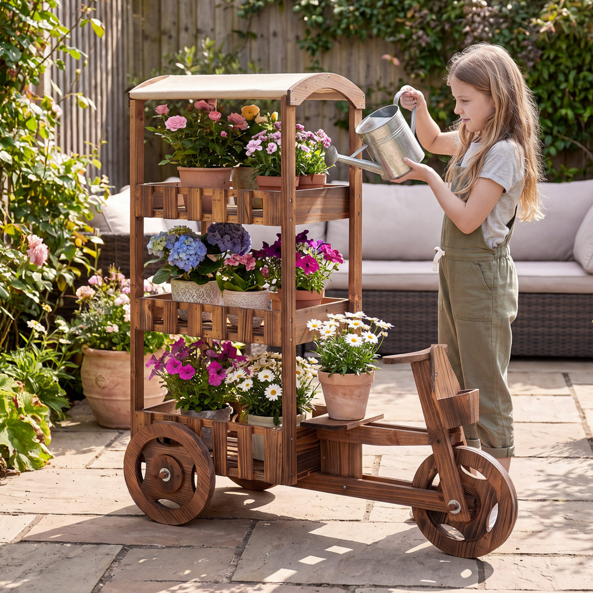 Brown three-tier tricycle plant stand with flowers as a person waters it outdoors
