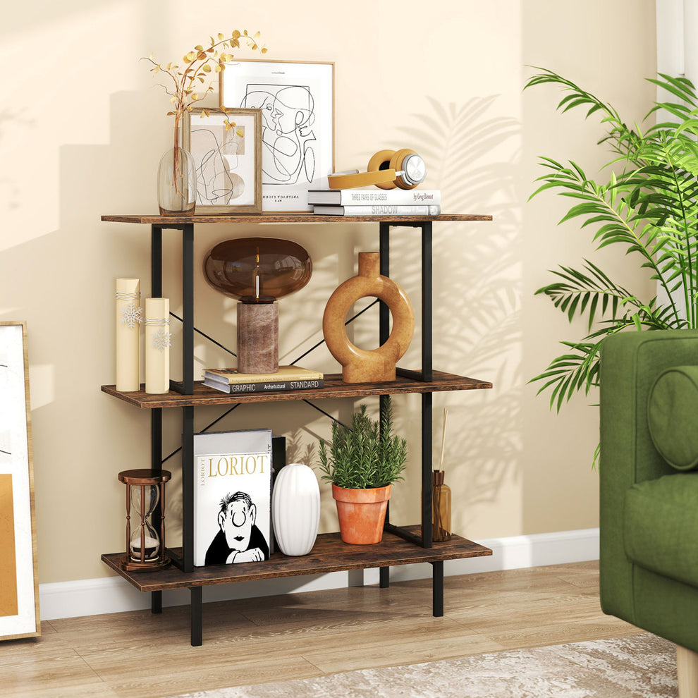 Three-tier rustic brown bookshelf with black metal frame, styled with books and decor beside a green sofa.