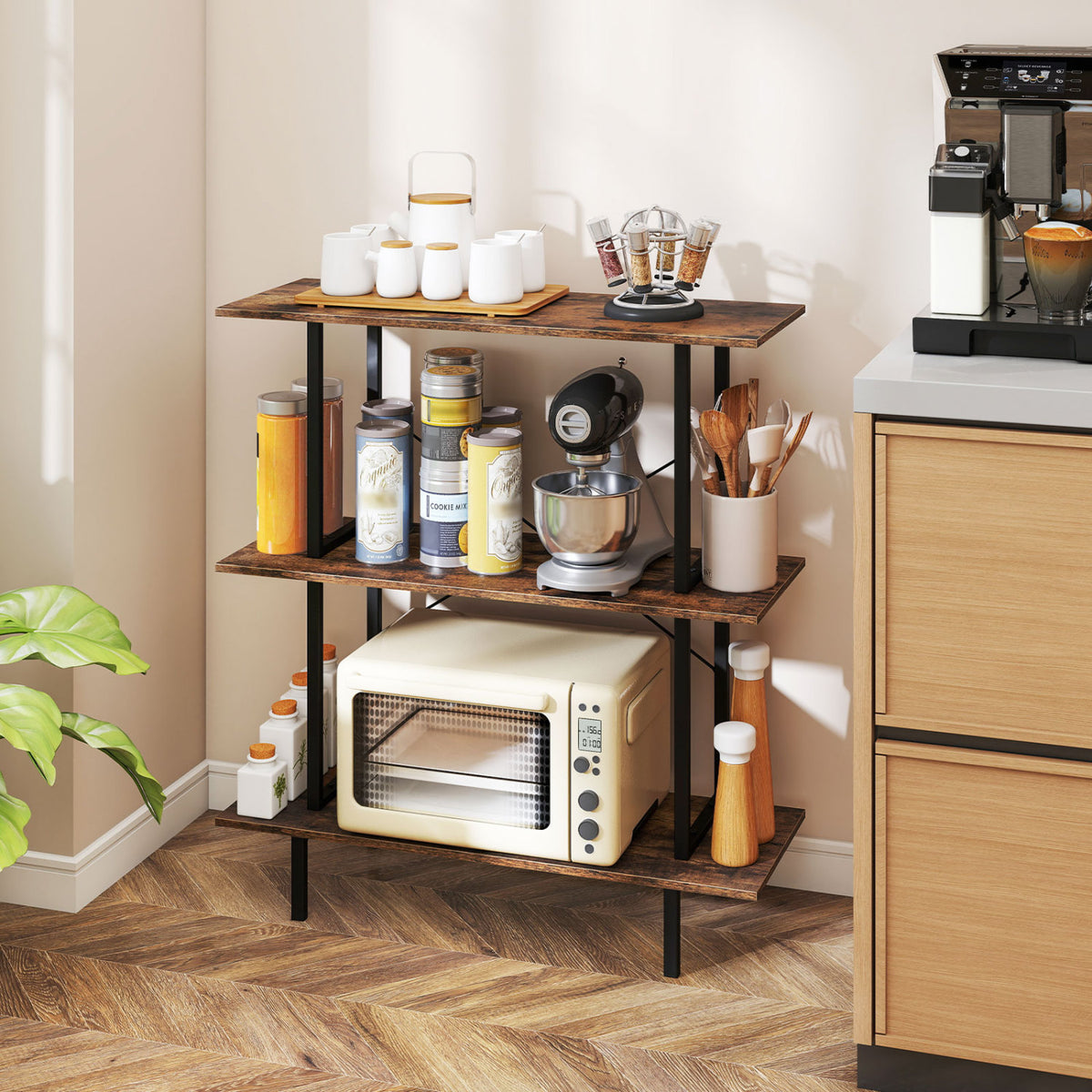 Three-tier bookshelf beside a kitchen counter, holding jars, cups, utensils, and a countertop oven.