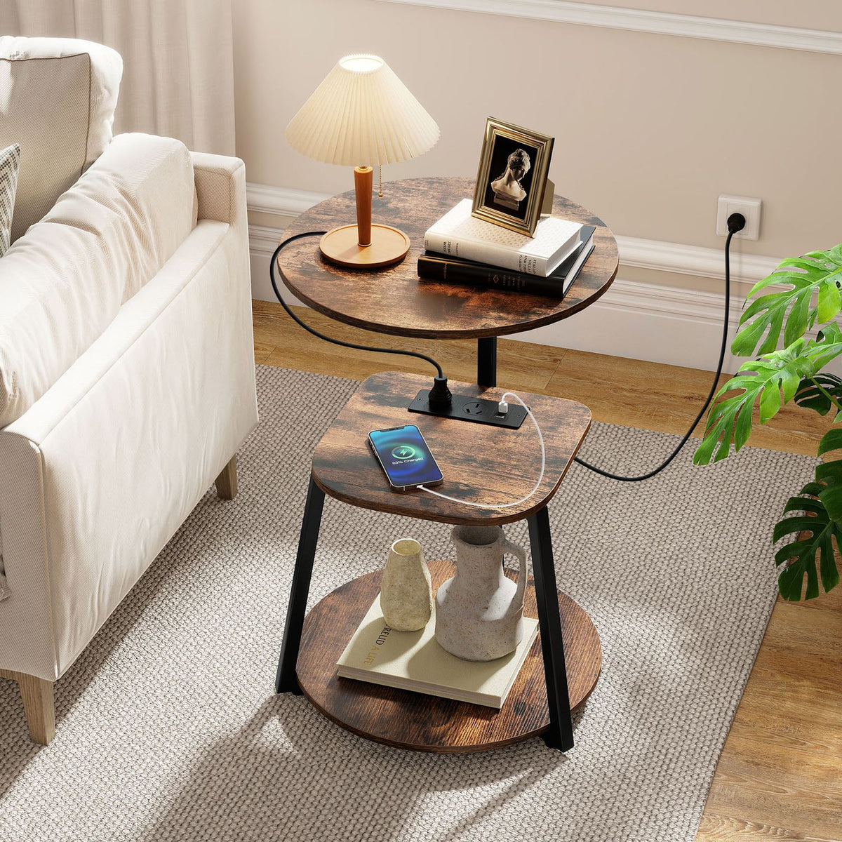 Three-tier round end table with charging station beside a sofa