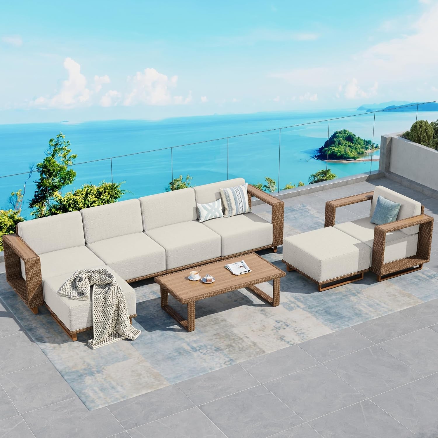 L-shaped modular sectional with chaise, coffee table and ottoman arranged overlooking ocean view.