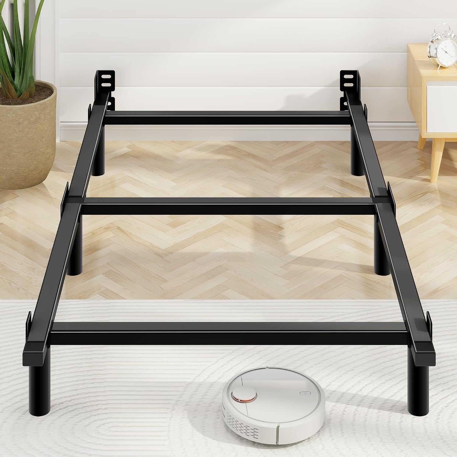 Low frontal view showing frame's center crossbeams and a round robot vacuum on the rug.