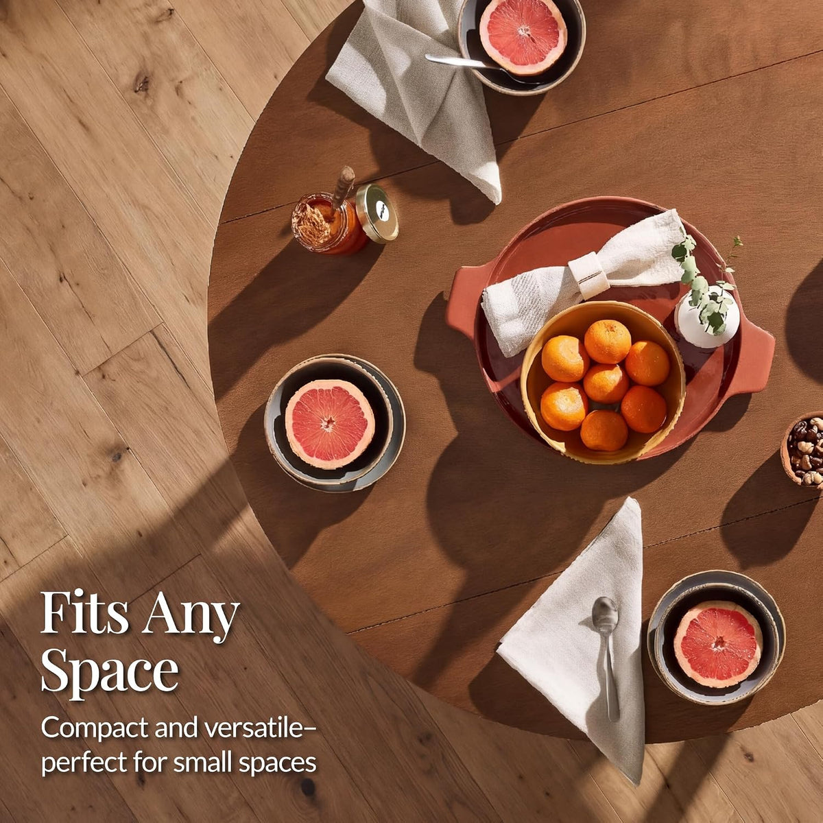 Overhead view of the round chestnut tabletop set with dishes and fruit