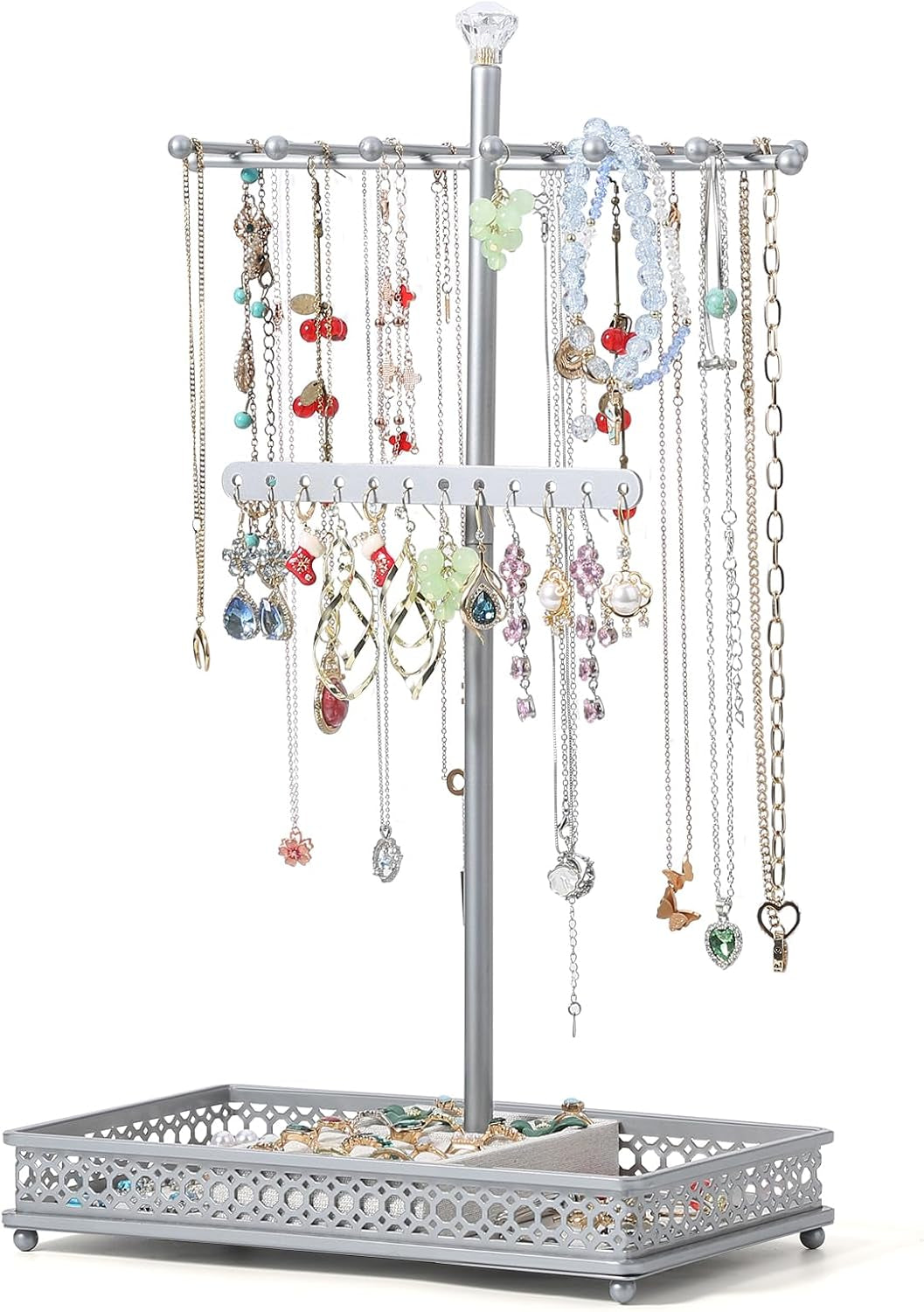 Silver-tone three-tier necklace stand on an ornate lattice tray holding rings and hanging necklaces