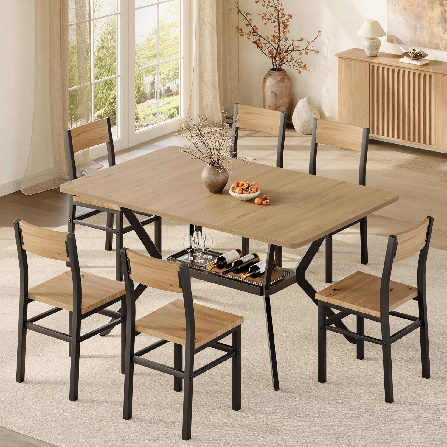 Elevated view of the light-walnut table and six chairs in a bright room, mesh storage shelf visible with wine glasses.