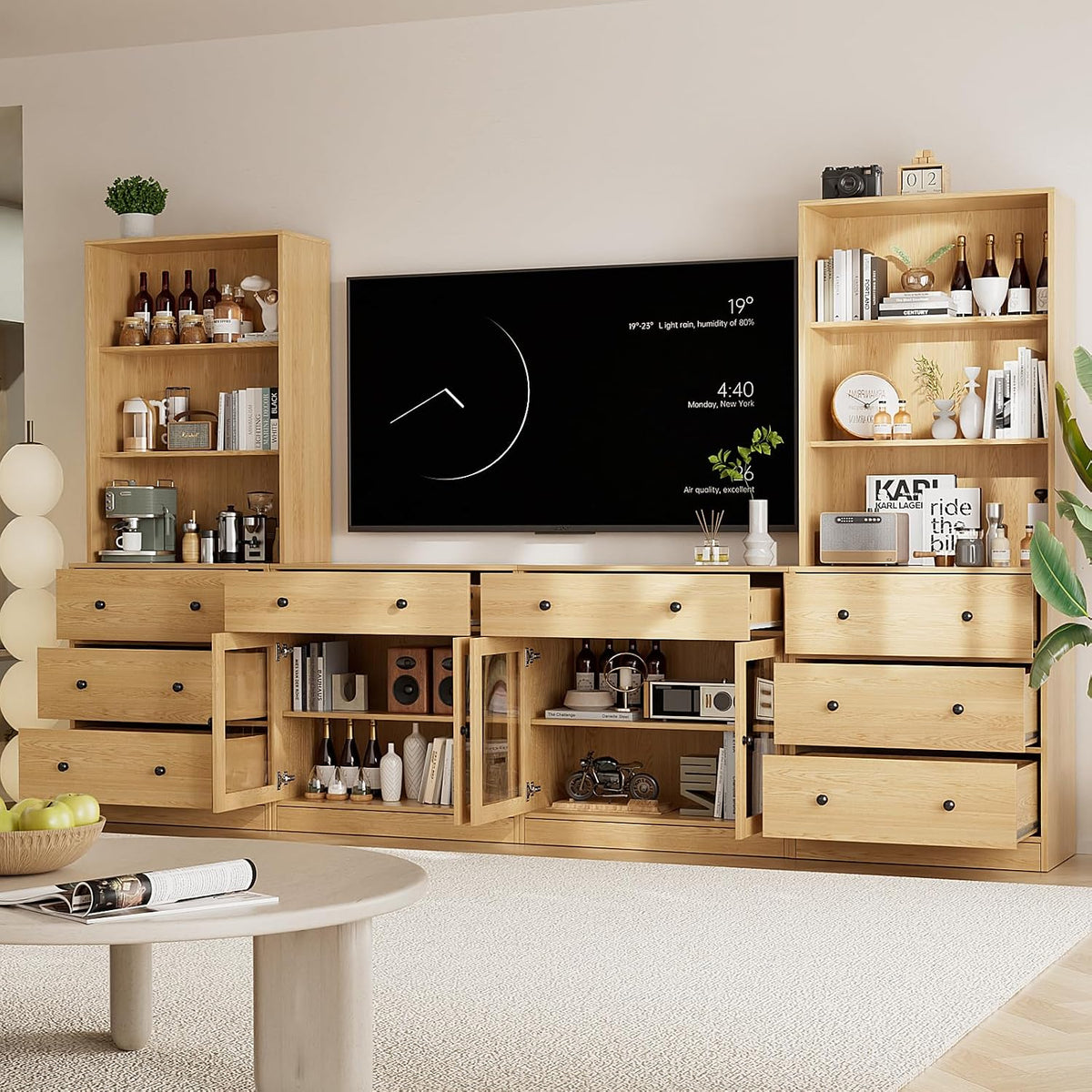 Close frontal view of the TV stand with open drawers and glass-front cabinet doors filled with decor.