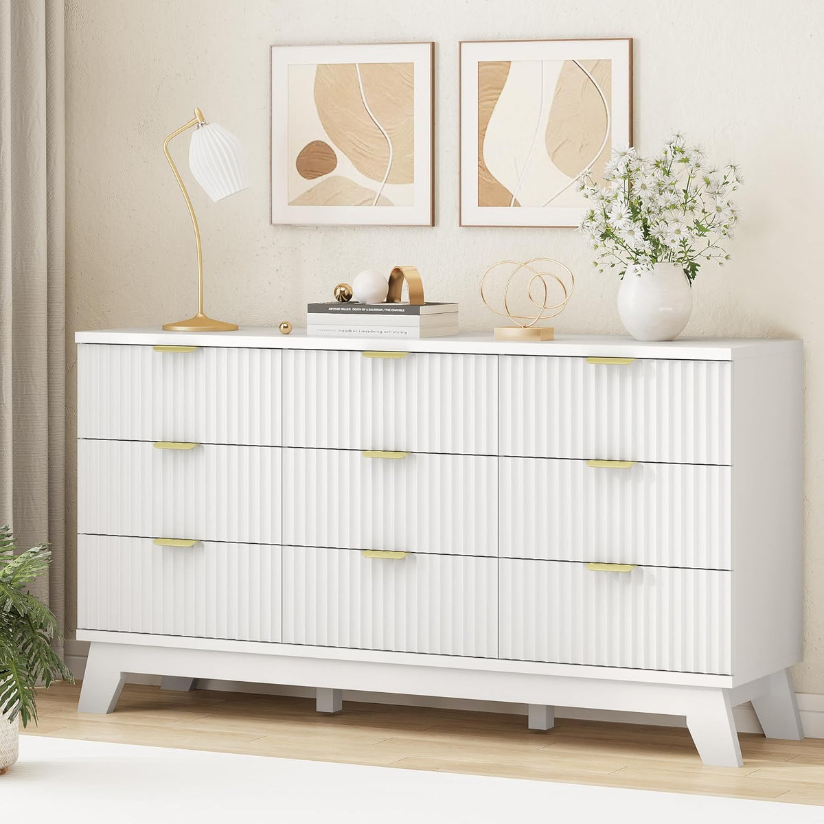 Angled front view of white dresser top styled with a lamp, books and a vase on the thick tabletop