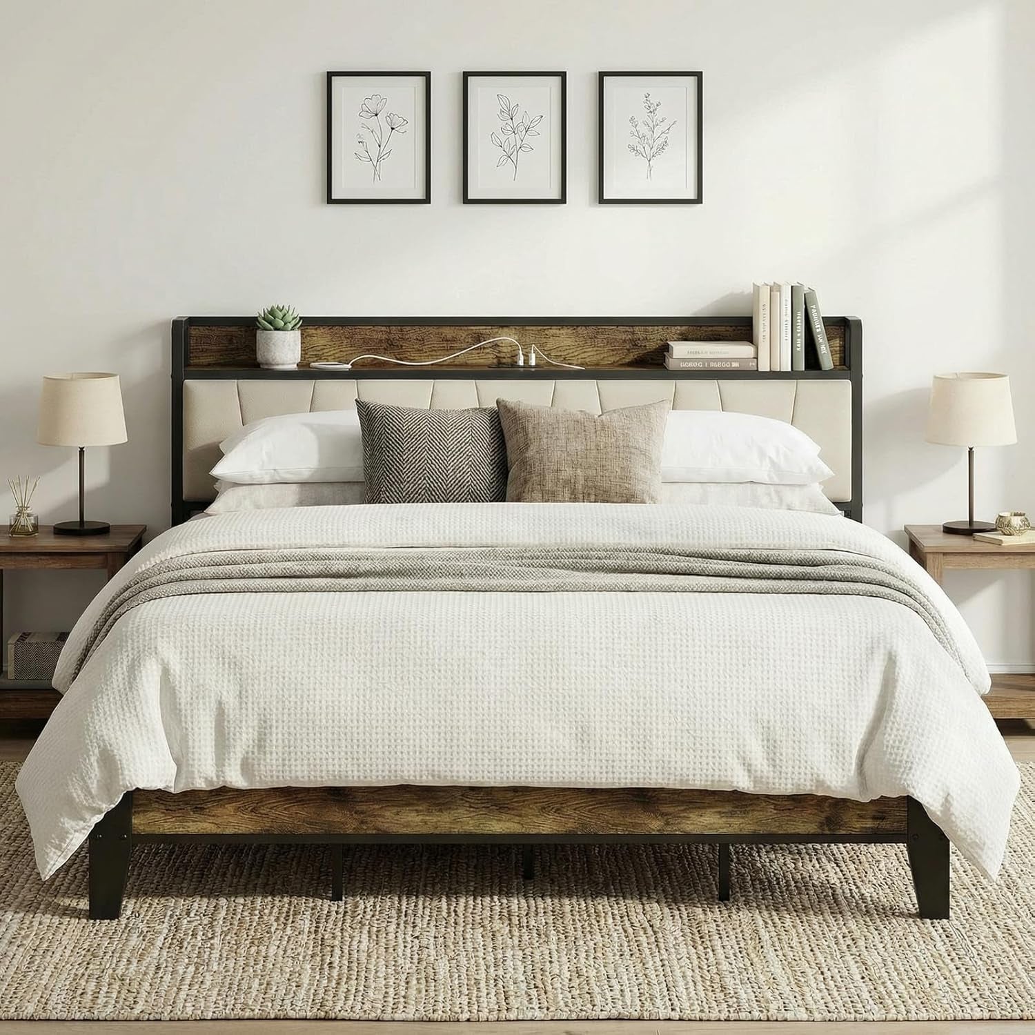 Front view of bed with rustic brown wood headboard, cream upholstered panel, white linens and two lamps on side tables.