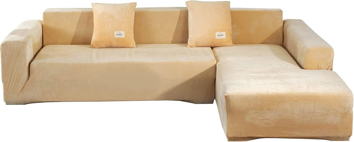 Front view of L-shaped sectional in light beige velvet slipcover with chaise on the right and two matching pillows.